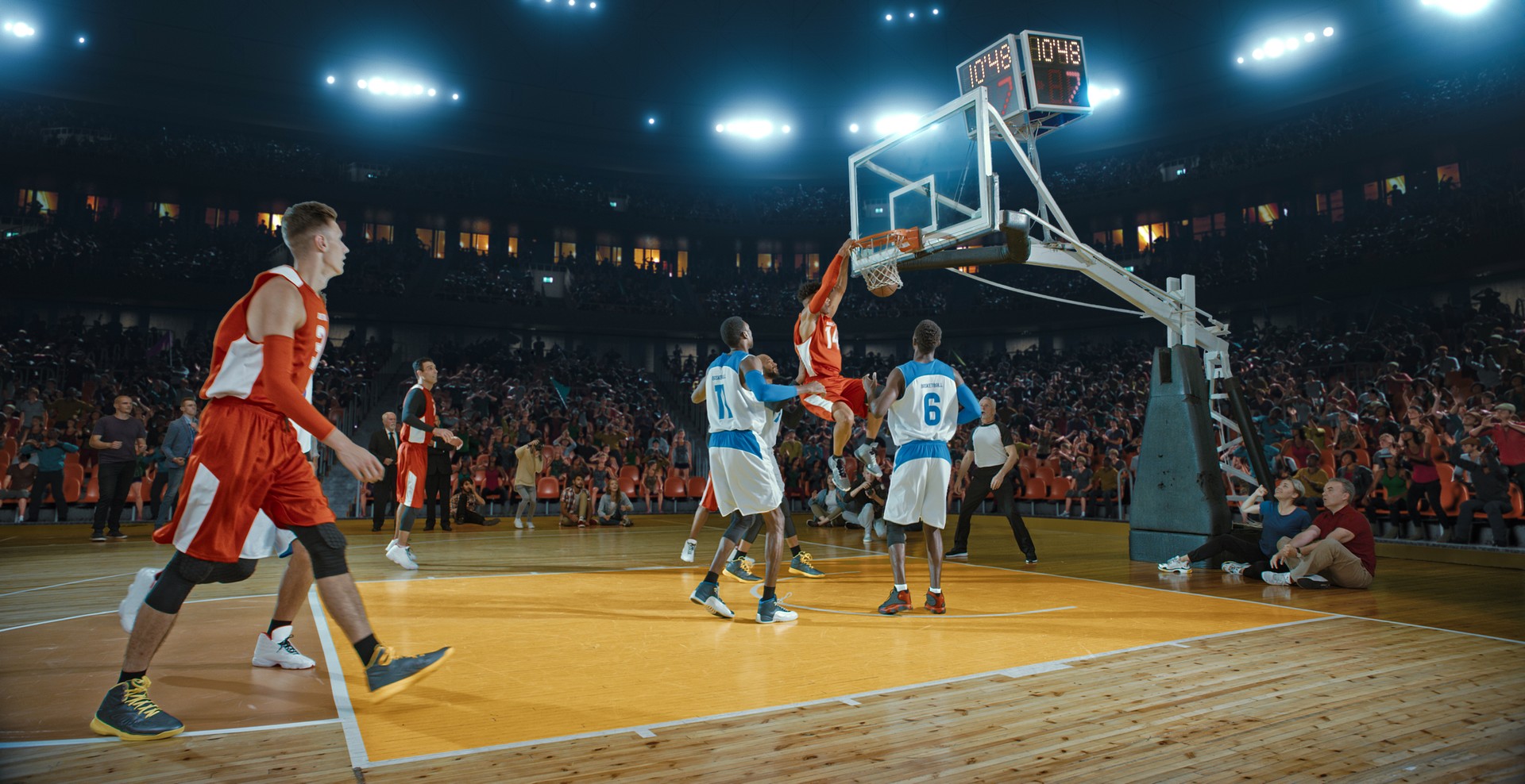 Basketball players on big professional arena during the game. Tense moment of the game. Celebration